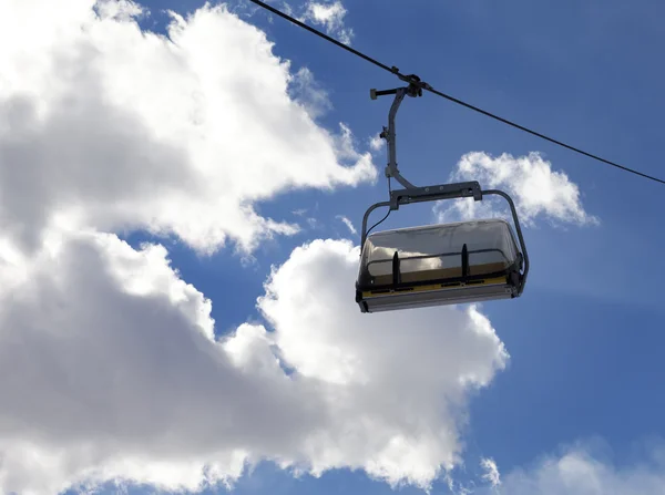 Chair-lift and sunlight sky — Stock Photo, Image