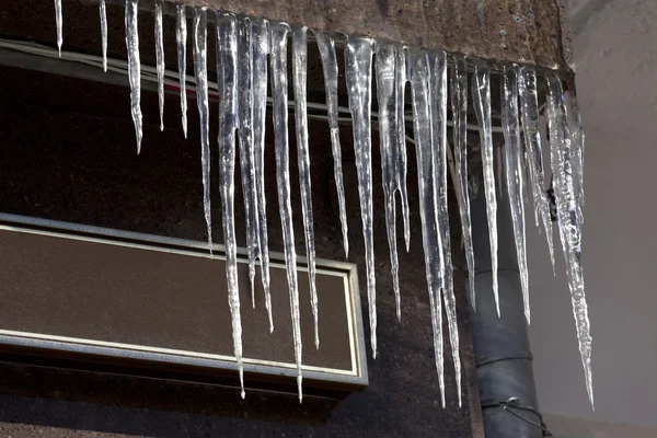 Roof of house with icicles — Stock Photo, Image