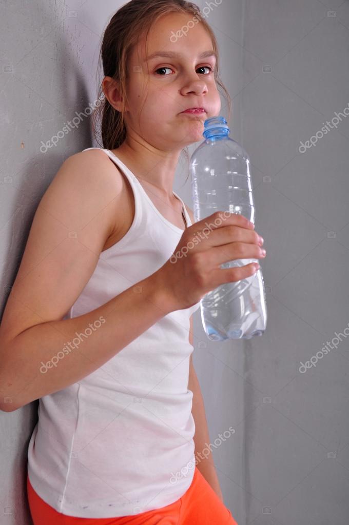 Portrait of young sportive teen girl with a bottle of drinking water Stock  Photo by ©Cherry-Merry 113908888