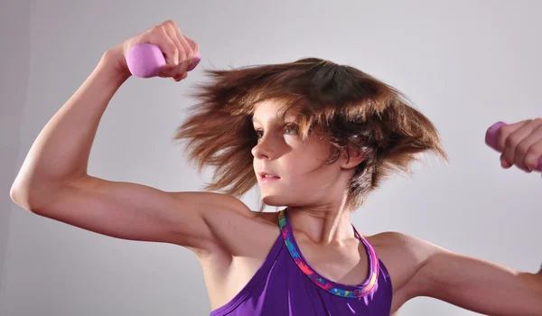 Child exercising with dumbells — Stock Photo, Image