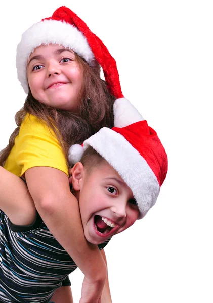 Glada barn med santa claus röda hattar — Stockfoto