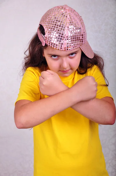 Cool teen age girl with a cap posing and gesturing — Stock Photo, Image