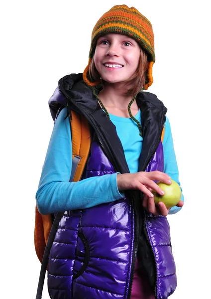 Glücklich lächelnde Schulmädchen mit Rucksack und Apfel isoliert über weiß — Stockfoto