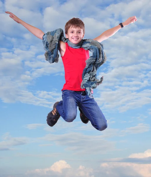 Full length portrait of running jumping boy in the sky — Stock Photo, Image