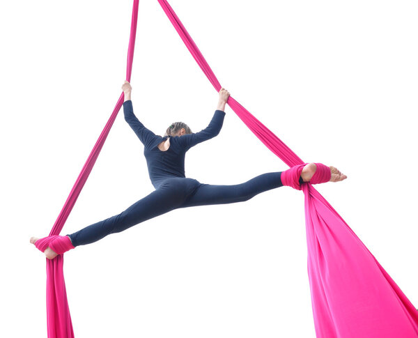cheerful child training on aerial silks, isolated over white