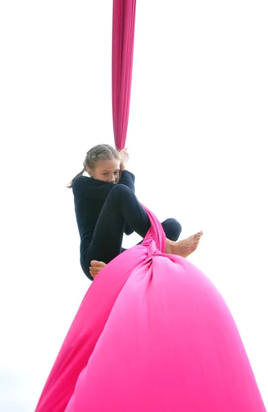 Scared child training on aerial silks, isolated over white — Stockfoto