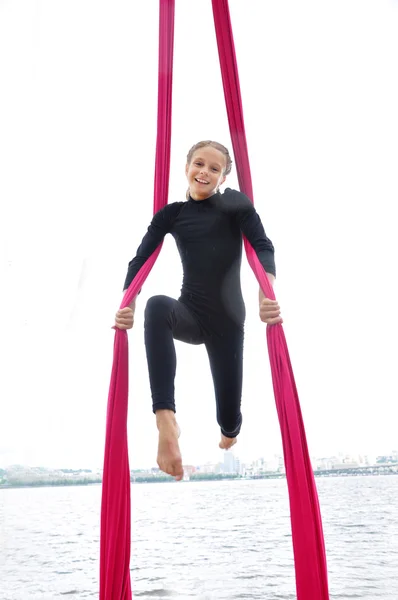 Cheerful child training on aerial silks outdoor — Stock Photo, Image