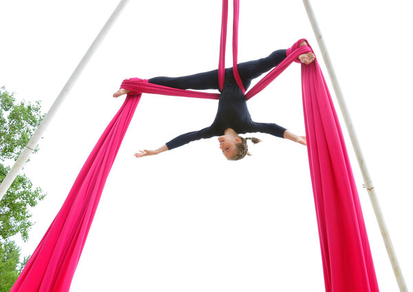 cheerful child training on aerial silks