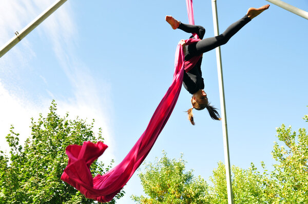 cheerful child training on aerial silks