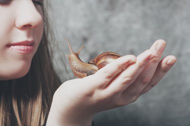 Young girl holding snail clipart