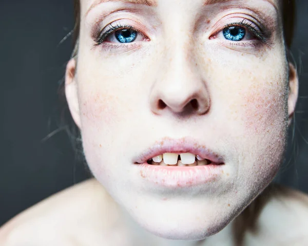 Funny female portrait with open mouth and blue eyes