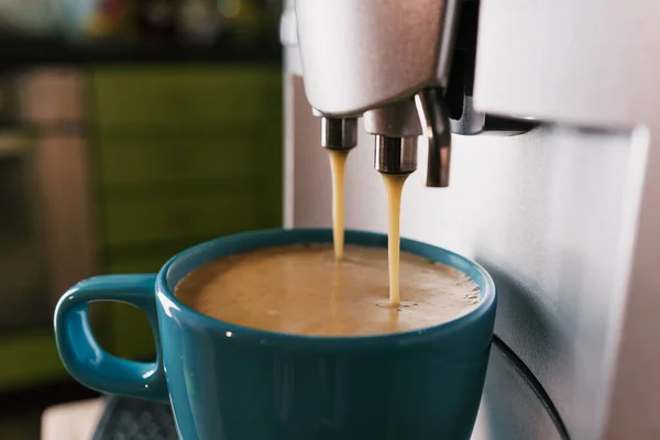 Morning coffee. Kitchen still life with coffee machine, cup and refreshing drink