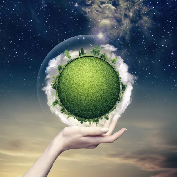 Green planet into human hand — Stock Photo, Image