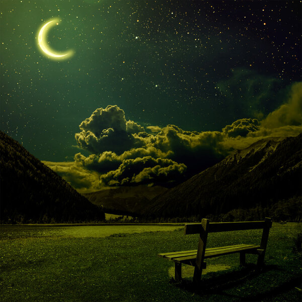 Bench for relaxing with a view on the night Alps in Austria. Elements of this image furnished by NASA