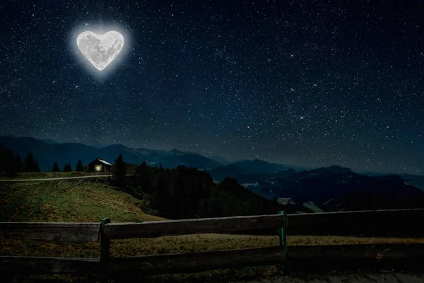 The moon heart-shaped shines over the lovers' house on valentine's day