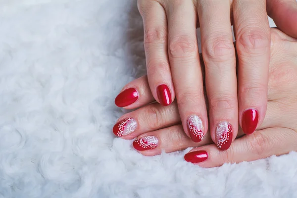 Red nail art with white lace with dots and lines