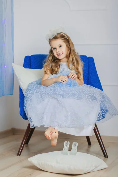 Little girl in light blue dress waiting Christmas — Stock Photo, Image