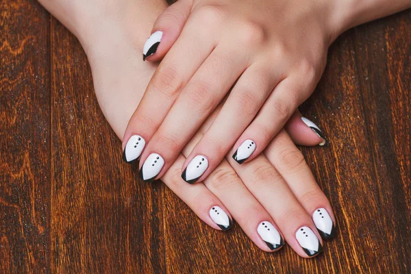 Black and white  nail art on wooden background — Stock Fotó