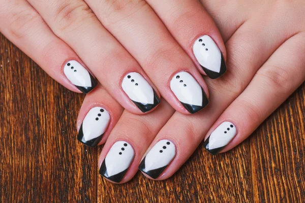 Black and white  nail art on wooden background — ストック写真