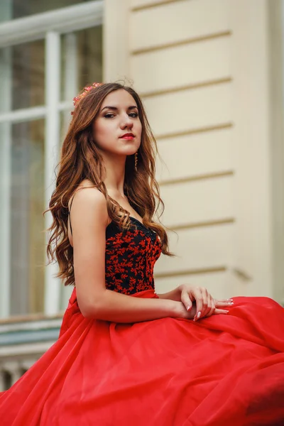 Beautiful young woman in red dress with corset — Stock Photo, Image