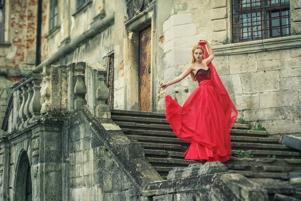 Beautiful young woman in fashion red dress — Stock Photo, Image