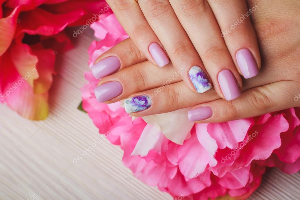 Lilac nail art with printed flowers on light background Stock ...