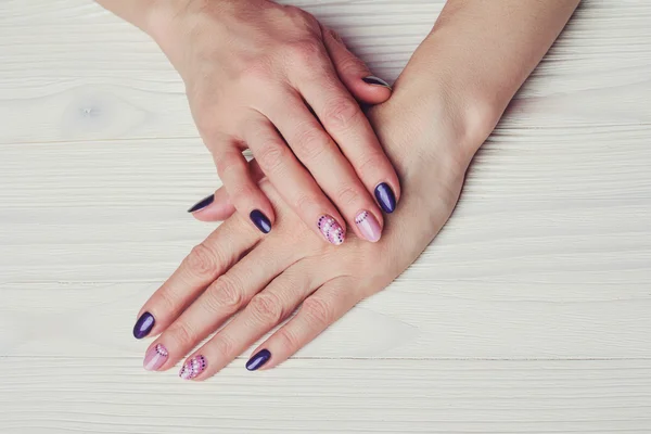 Nail art with purple and pink colors