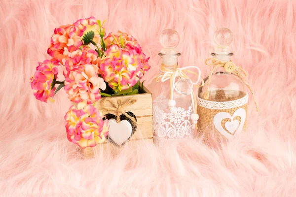 Beige Wooden Box Flowers Bottles Pink Fur Background — Stock Photo, Image