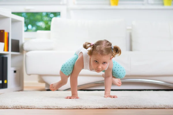 Cute little girl morning exercises — Stock Photo, Image