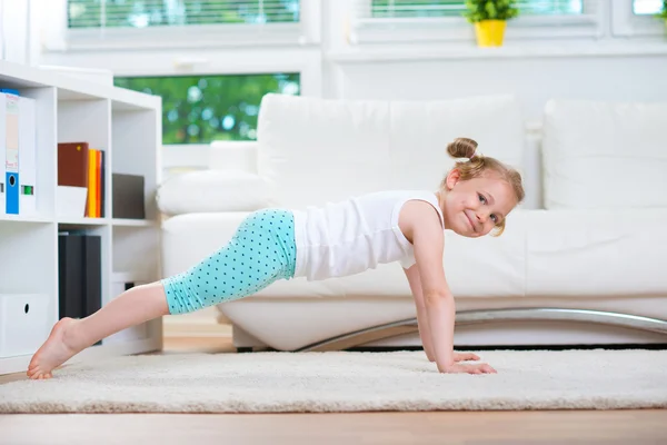 Cute little girl morning exercises — Stock Photo, Image