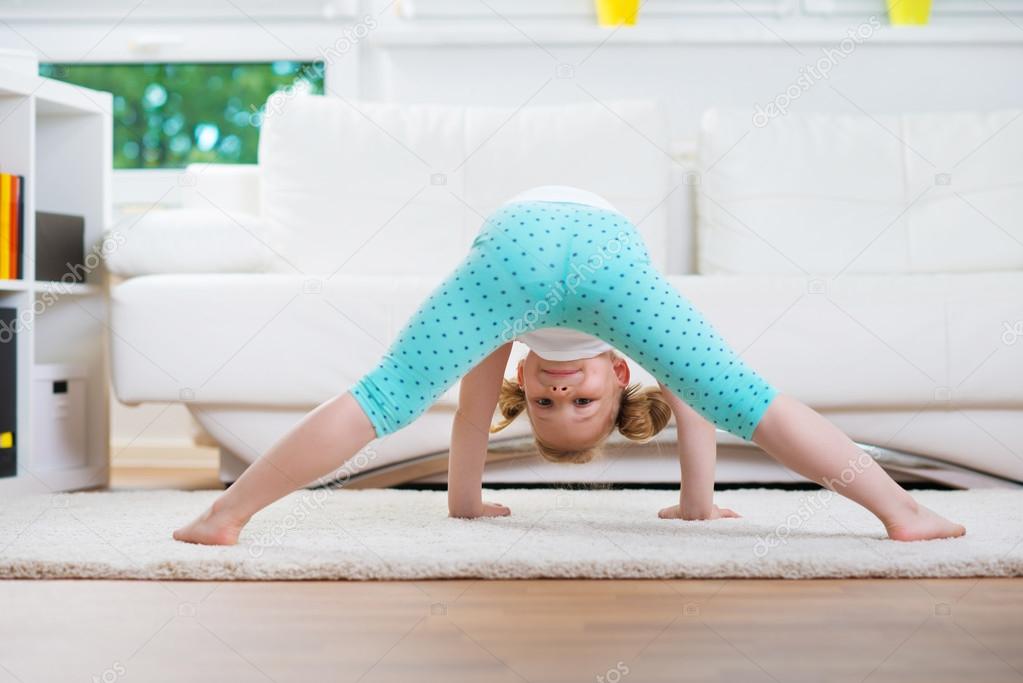 Cute little girl morning exercises Stock Photo by ©petrograd99
