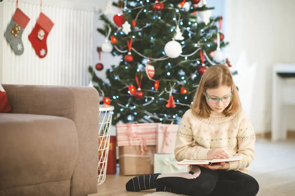 Portré Csinos Kislány Olvasás Könyvet Közel Díszített Karácsonyfa — Stock Fotó