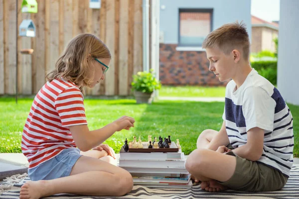 Two Happy Children Playing Chess Backyard Sunny Day While Summer — Stockfoto