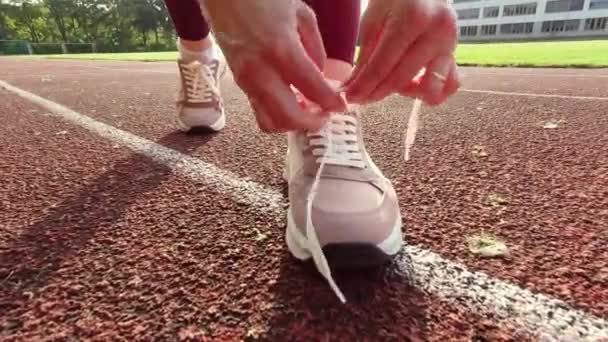 Fps Video Sporty Woman Lace Shoe Laces Jogging Stadium Sunset — Stock Video