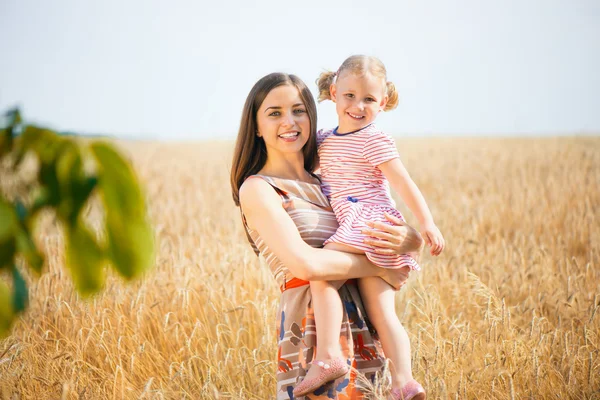 Красивая молодая мать с дочерью счастливы в солнечный день — стоковое фото