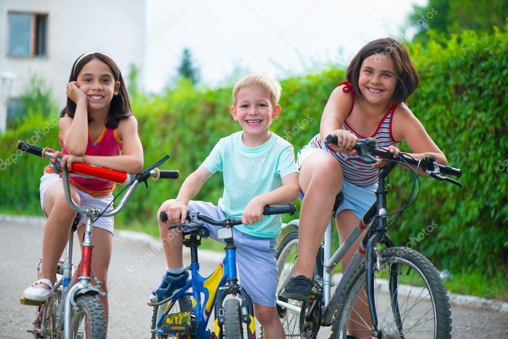 Portrait of three little cyclists