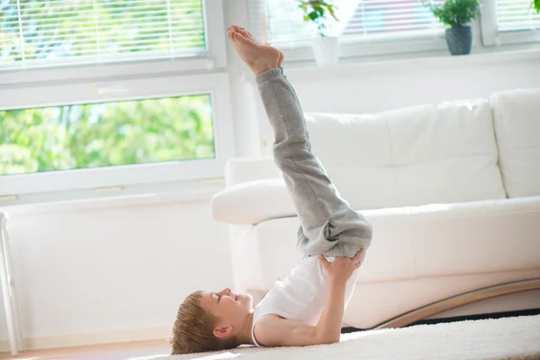 Happy little  boy exercising at home — Stock fotografie