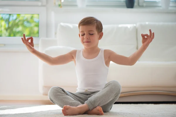 Happy little  boy exercising at home — Zdjęcie stockowe