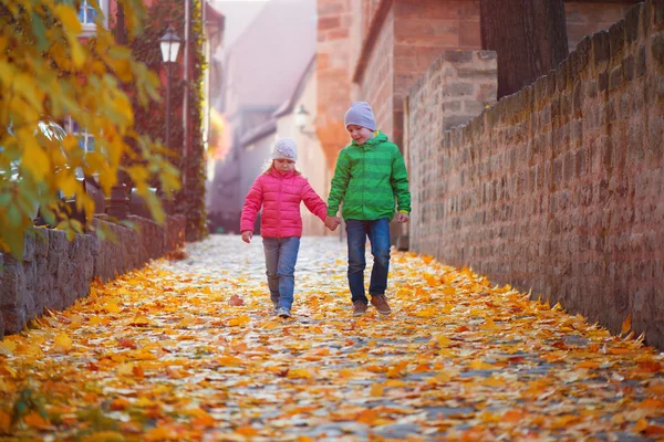 Cute children walking in autumn town — Stock Photo, Image