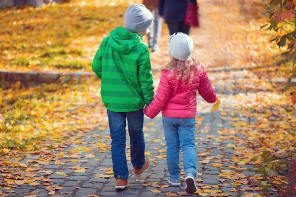 Cute children walking in autumn town — Stock Photo, Image