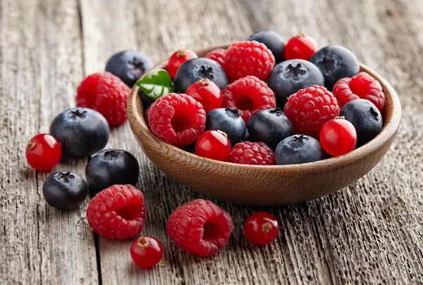 Ripe berry in a wooden plate — Stock Photo, Image