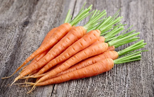Fresh carrot on a wooden board — Stock Photo, Image