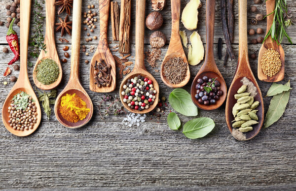 Herbs with spices on a wooden background