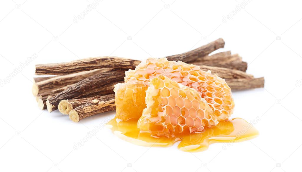 Licorice root with honeycomb on white background