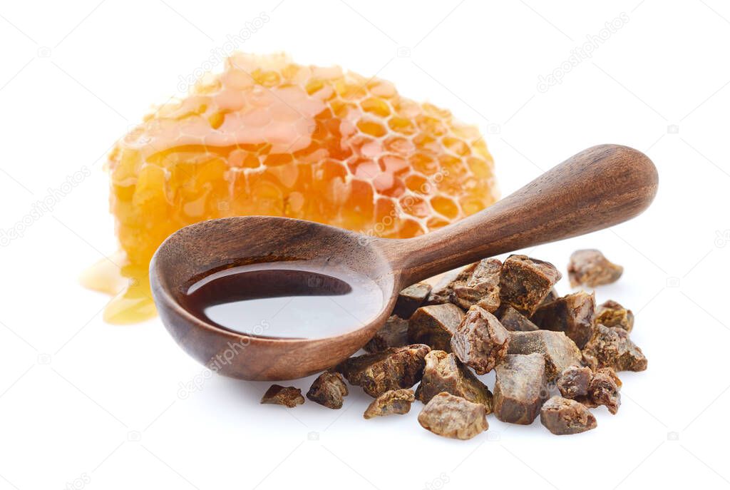 Propolis tincture in wooden spoon on white background. Natural antibiotic