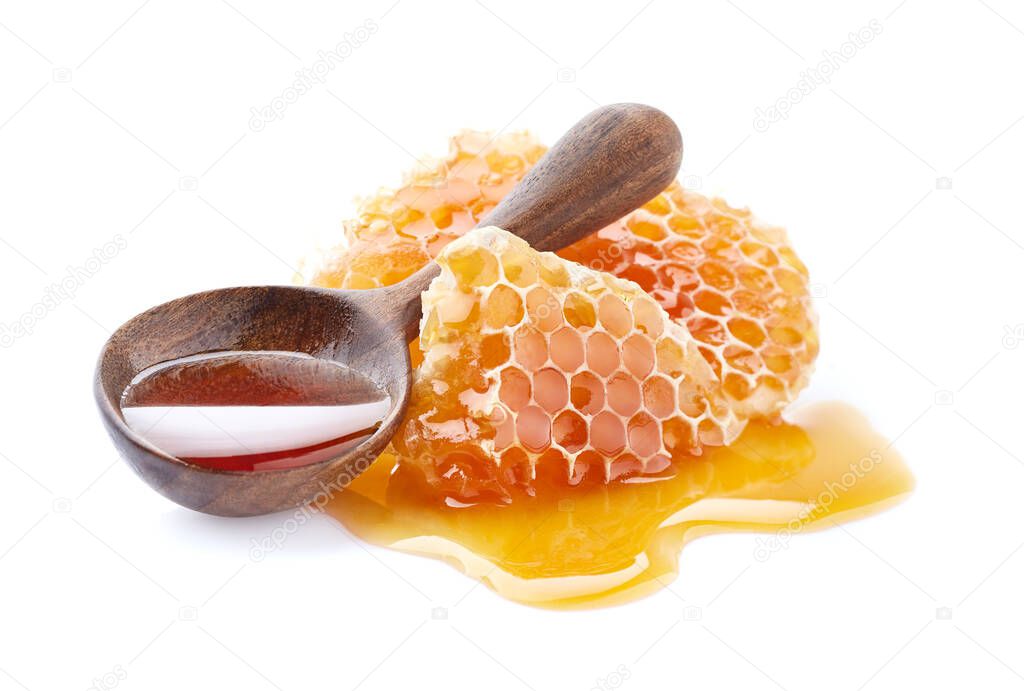 Honeycombs with  wooden spoon on white background