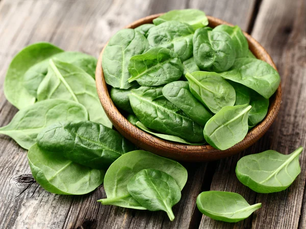 Spinach on a wooden background — Stock Photo, Image