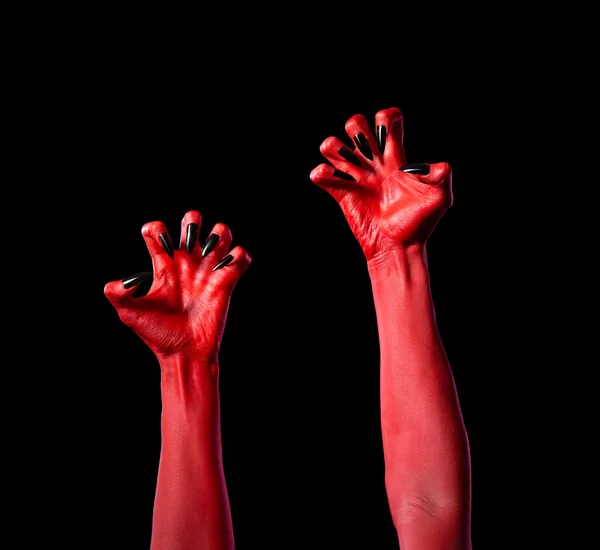 Mains du diable rouge avec des ongles noirs, véritable body-art — Photo