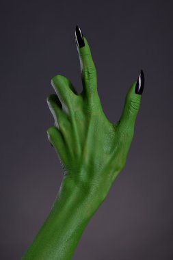 Green witch hand with sharp black nails clipart
