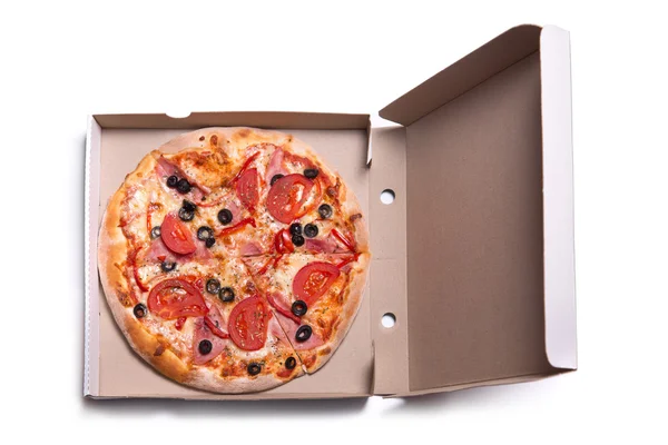 Tasty pizza with ham and tomatoes in box — Stock Photo, Image